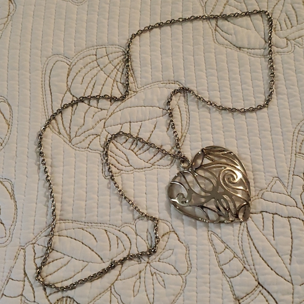 Fashion jewelry 2"x2" silvertone heart on 32" chain.